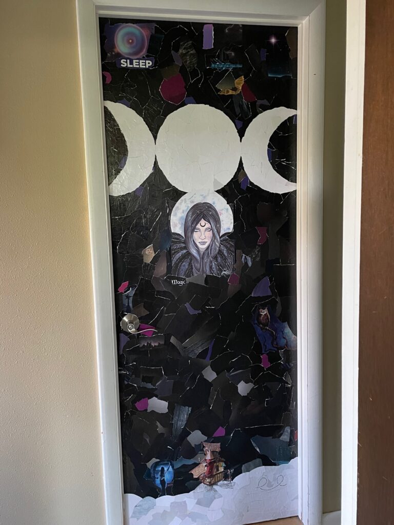 A door decoupaged with a triple moon and a moon fairy.